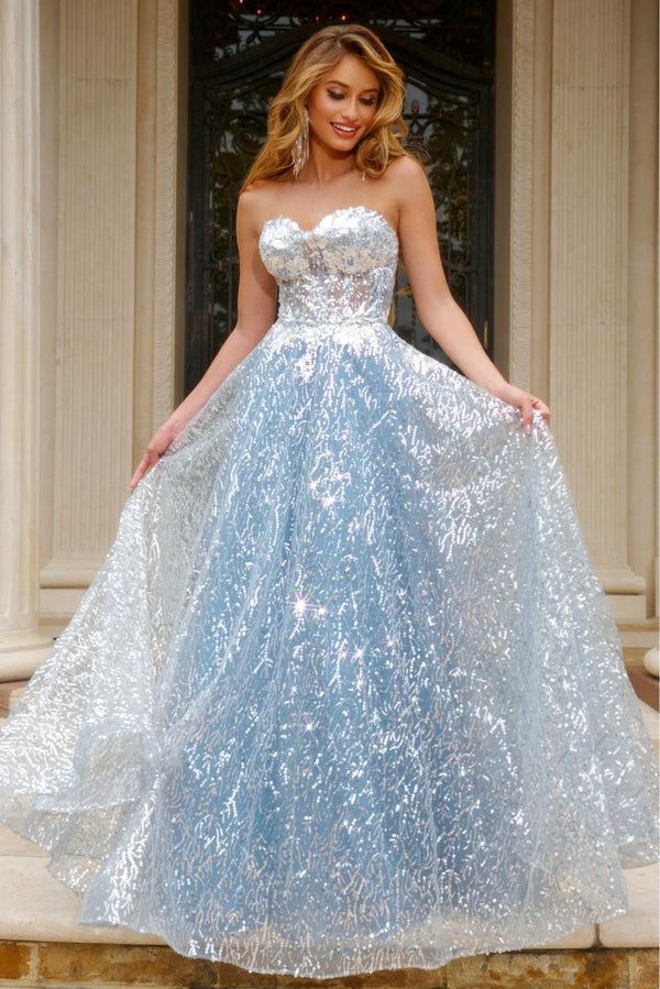 Woman with long blonde hair wearing a strapless silver and light blue sequined prom dress standing outdoors