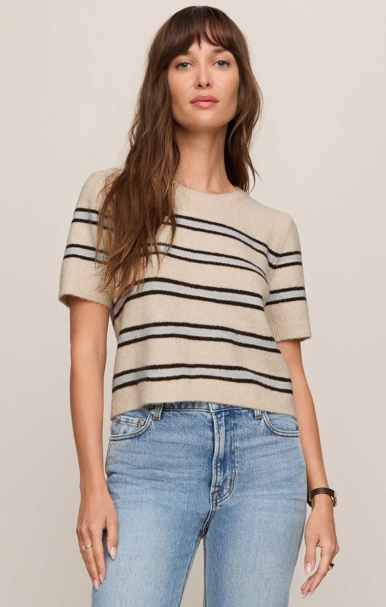 Woman wearing Light Oatmeal Heather Gatewood Stripe Sweater by z supply with short sleeves and horizontal stripes.