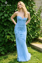 Faviana Prom Dress Style 11472 features a strapless blue gown with floral patterns, shown outdoors with greenery background