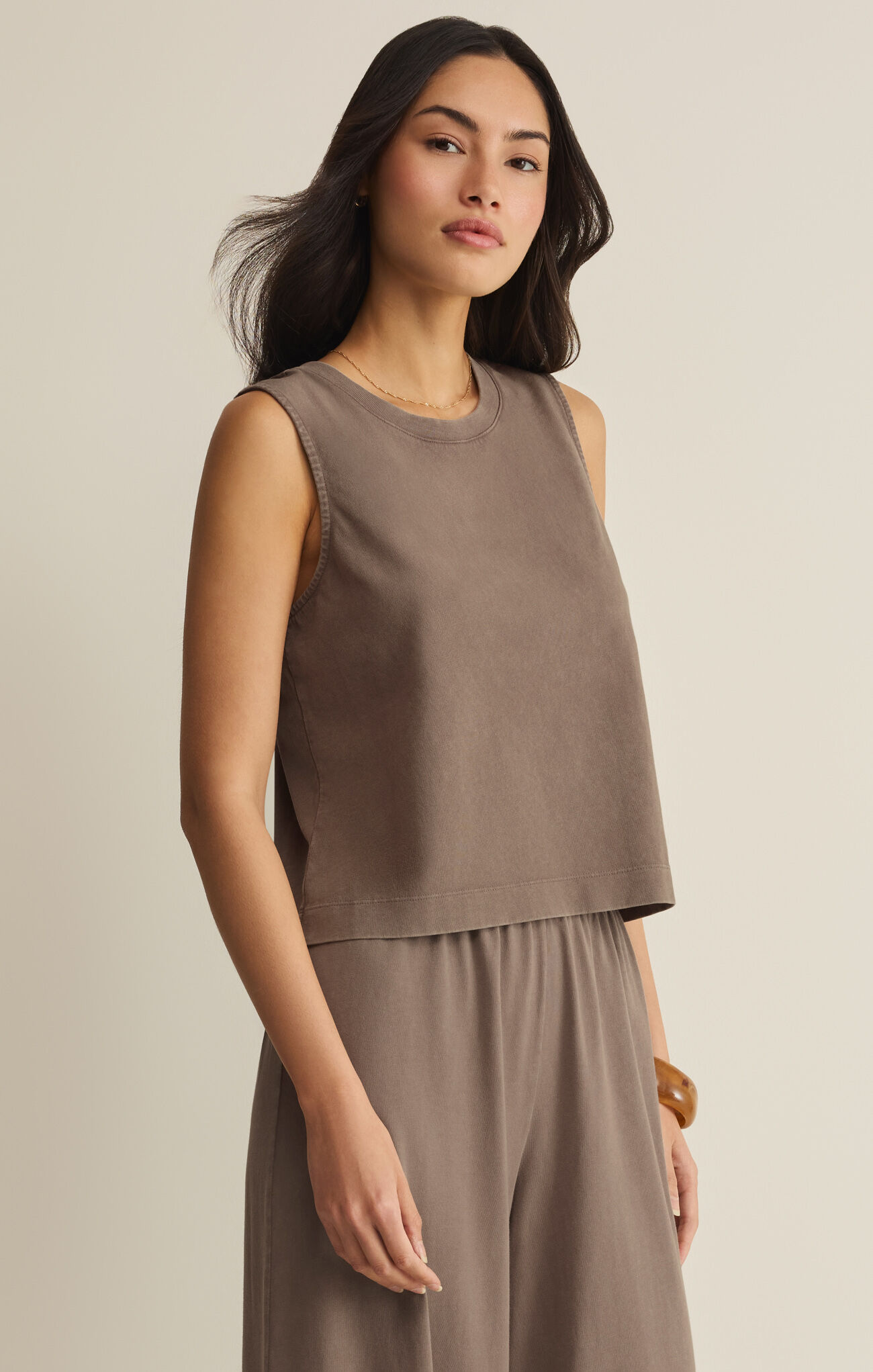 Woman wearing Perfectly Taupe Sloan Jersey Muscle Tank by z supply in a relaxed, casual style against neutral background