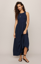 Woman wearing navy Eclipse Charlotte Midi Dress by z supply with sleeveless top and flowing skirt midi length
