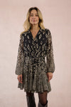Molly Bracken Estelle Dress in printed black voile with tie waist, ruffled hem, and long sheer sleeves.