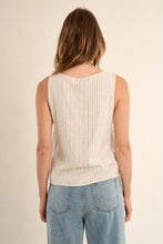 Back view of a woman wearing Molly Bracken Light Beige Luxe Tank with thin vertical stripes and light denim jeans