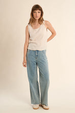 Woman wearing Light Beige Luxe Tank by Molly Bracken paired with light blue wide-leg jeans and white sneakers