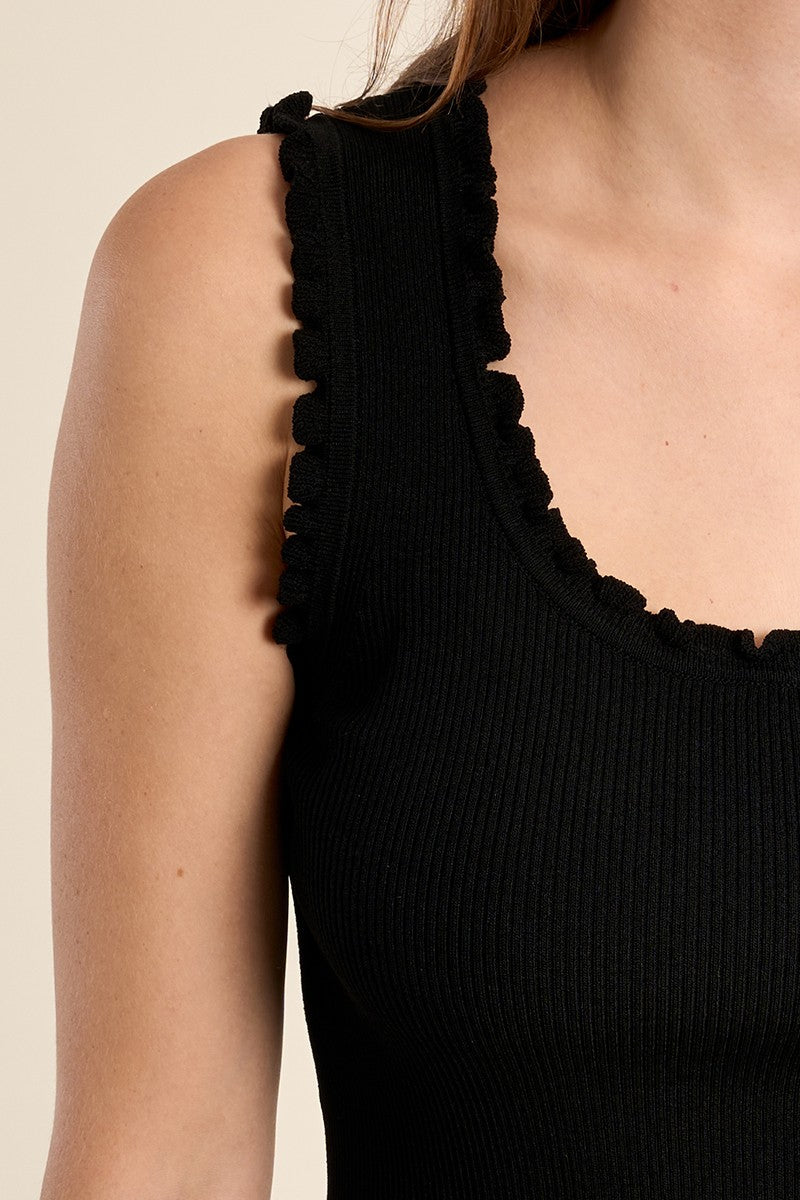 Close-up of a black Ruffle Trim Tank Top by Molly Bracken featuring delicate ruffled edges on a ribbed fabric.