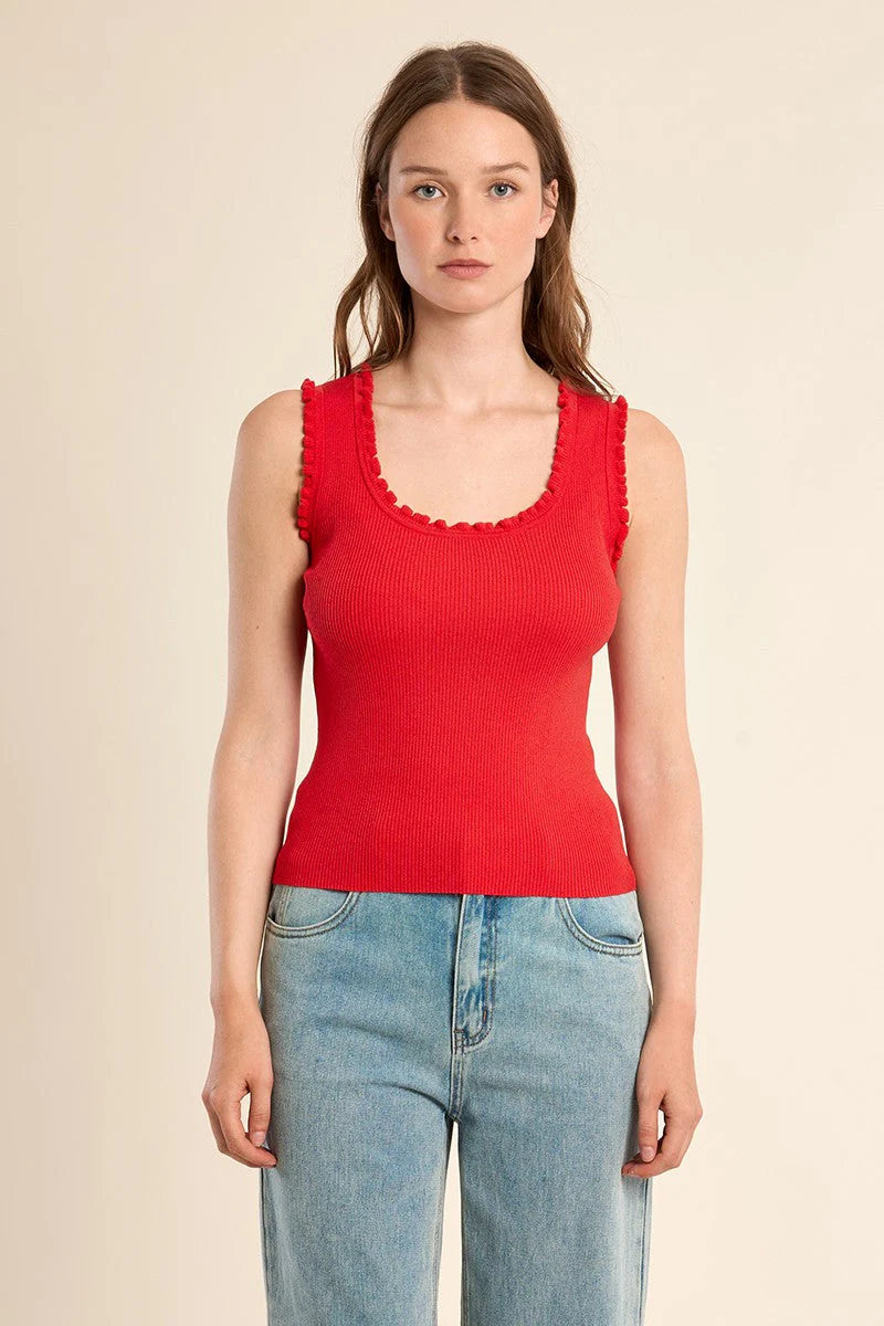 Woman wearing Molly Bracken Ruffle Trim Tank Top in vibrant red with delicate ruffle edges styled with light denim jeans