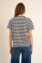 Back view of a woman wearing Navy Blue Stripe V-Neck Tee by Molly Bracken with horizontal navy stripes and short sleeves