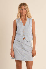 Woman wearing a sleeveless Blue Stripe Vest by Molly Bracken with button details and vertical stripes.