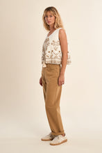 Woman modeling embroidered White Sands Vest by Molly Bracken with casual tan pants and white sneakers
