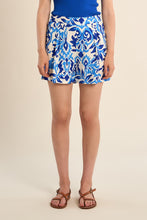 Front view of a woman wearing Blue Alizee Ladies Woven Shorts by Molly Bracken with a blue and white pattern and brown sandals