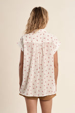 Back view of a woman wearing an OffWhite Soft Bloom Shirt by Molly Bracken with small red floral print and short sleeves