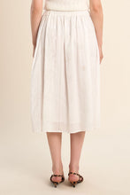 Back view of a model wearing the OffWhite Stella Skirt by Molly Bracken with delicate eyelet details and a midi length.