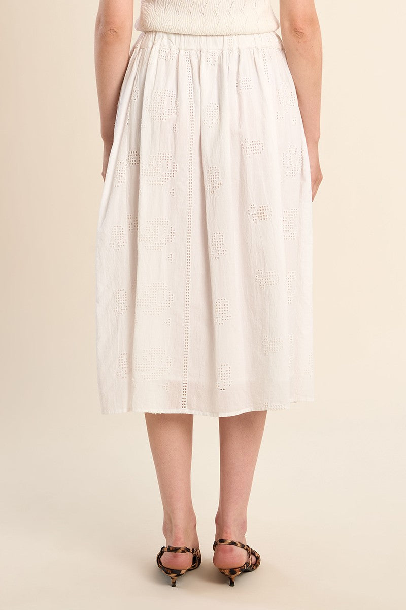 Back view of a model wearing the OffWhite Stella Skirt by Molly Bracken with delicate eyelet details and a midi length.