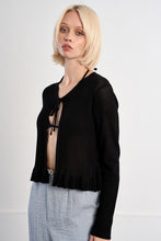 Model wearing a Molly Bracken Black Belle Cardigan with a textured knit and ruffled hem detail