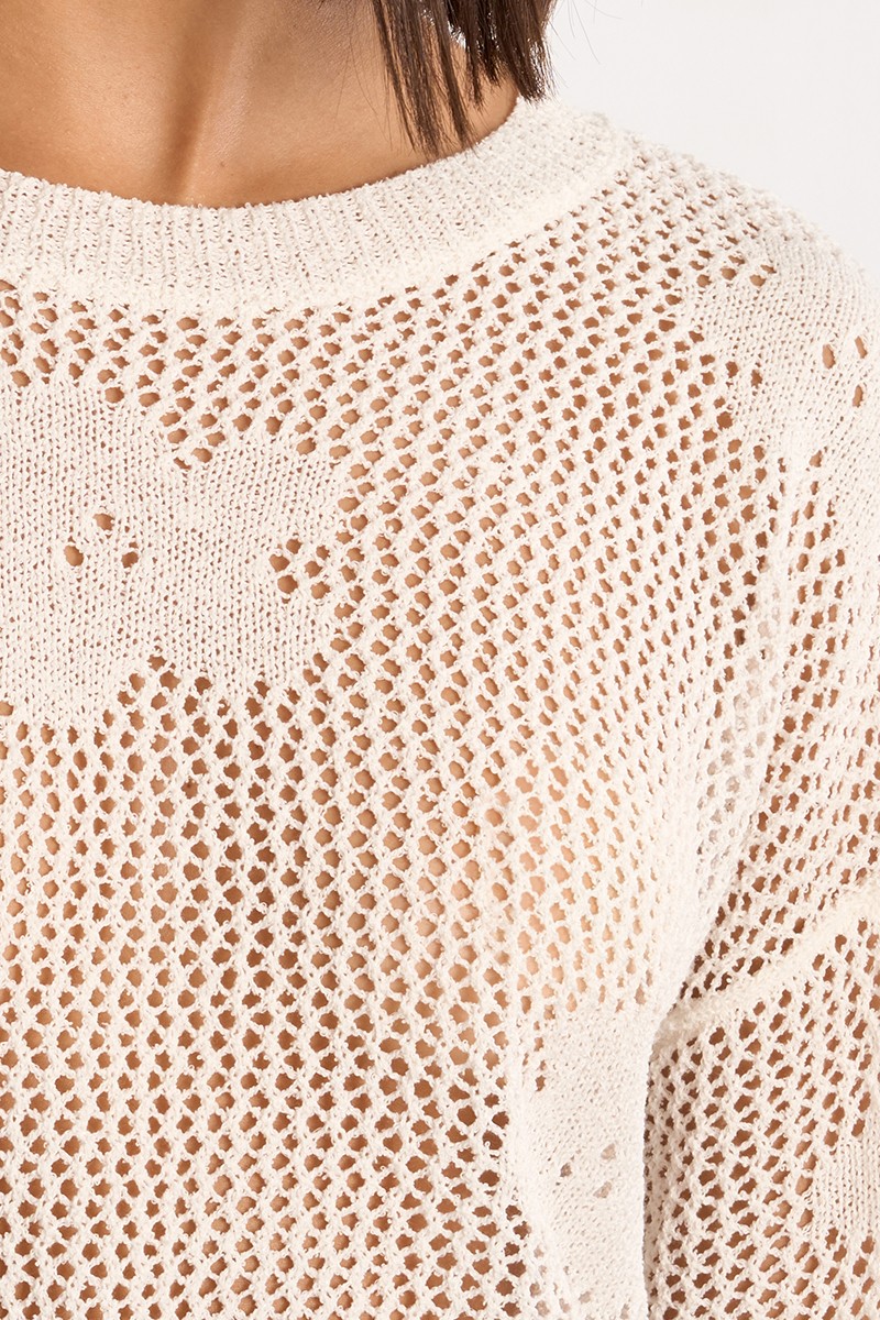 Close-up of a delicate mesh knit pattern with floral details on the White Petal Knit Sweater by Molly Bracken