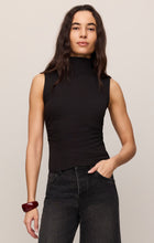 Woman wearing a sleeveless Black Silva High Neck Tank by z supply paired with dark jeans and a red bracelet