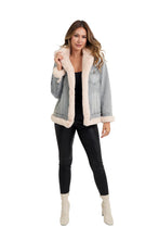 Love Token Susan denim jacket with cream lining and trim, worn open over a top