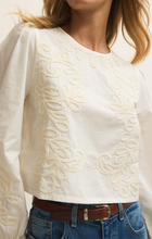 White Tatiana Poplin Top by z supply with intricate embroidery and a refined fit, styled with blue denim jeans and brown belt
