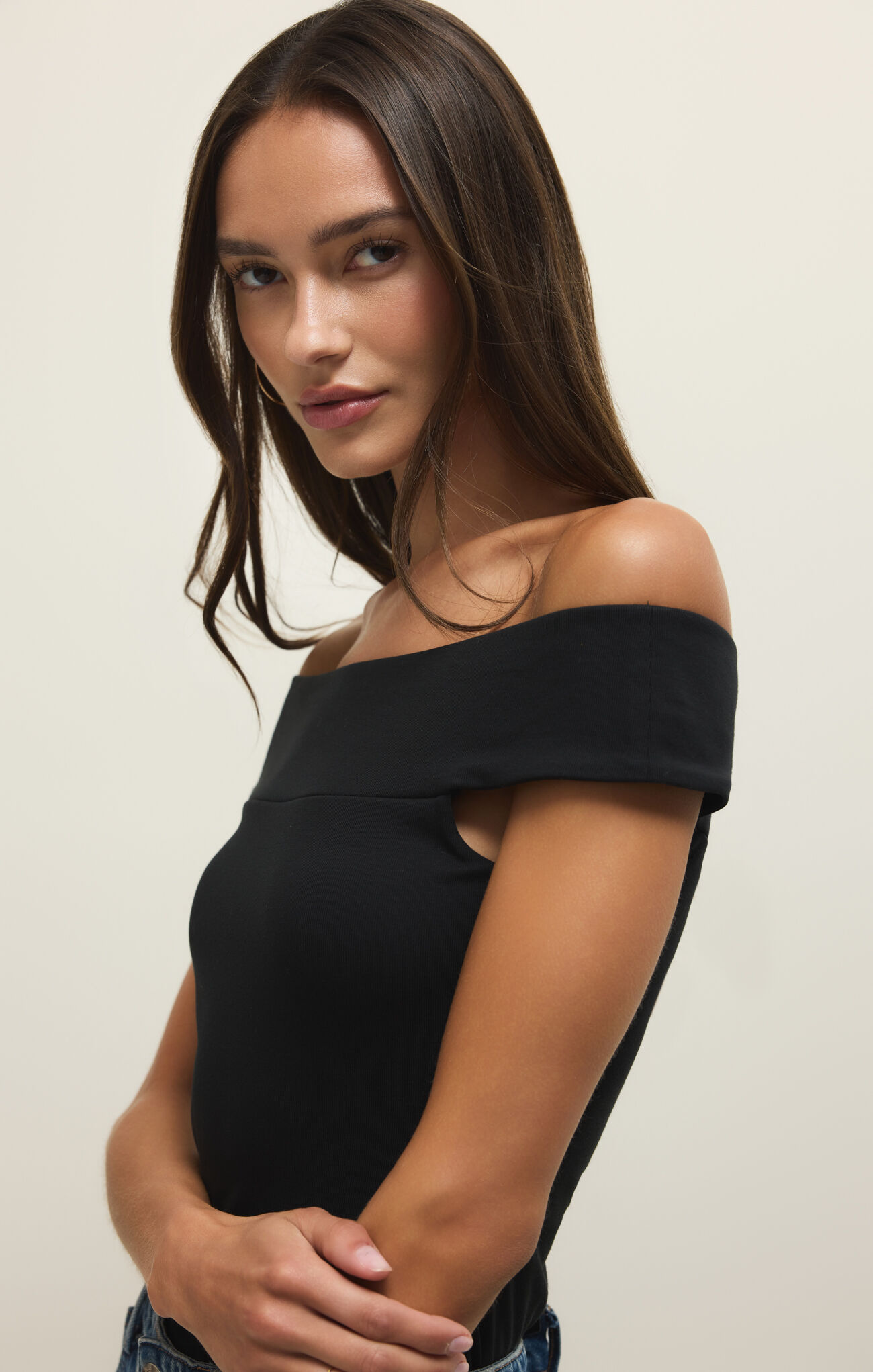 Model wearing the Black Second Skin Off Shoulder Top by z supply with a sleek, form-fitting, minimalist design