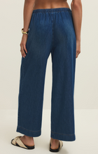 Back view of z supply Deep Water Daycation Denim Utility Pant in deep blue with elastic waistband and wide leg design