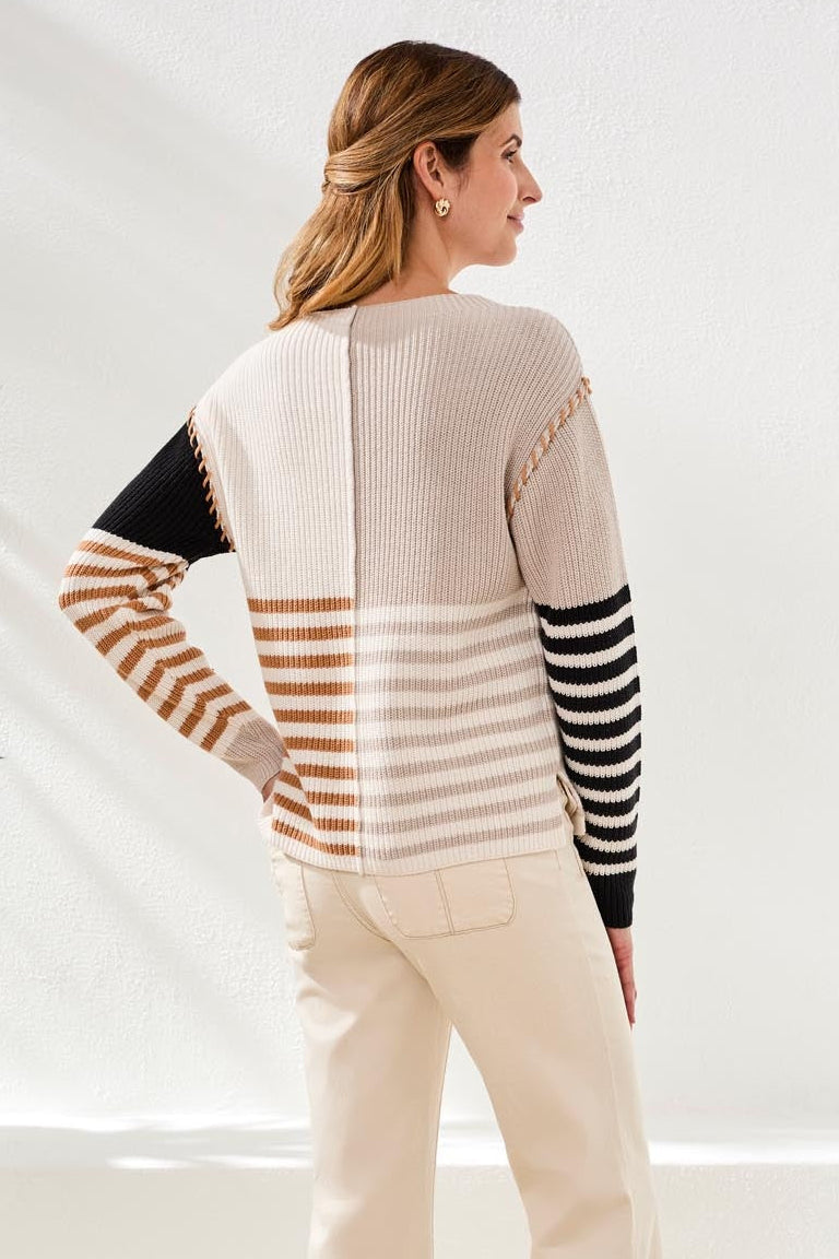Back view of woman wearing Tribal Multi Stripe Textured Boat Neck Sweater with beige and black striped sleeves