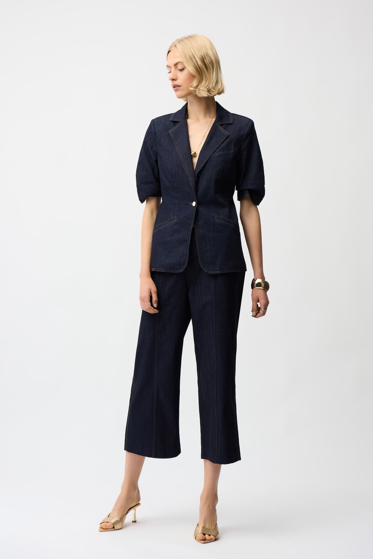 Model wearing Joseph Ribkoff Dark Blue Denim Fitted Blazer with matching cropped pants against white background