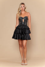 Woman wearing a strapless Black Ruffle Rhinestone Homecoming Dress by Ed Young with layered ruffles and sparkling details.