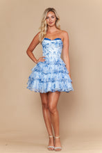 Woman modeling Blue Print Ruffle Dress by Ed Young, strapless with layered ruffle skirt in light blue floral print