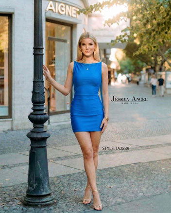 Jessica Angel Homecoming Dress Style 2839 worn by model standing by street lamp in a blue fitted sleeveless dress