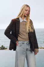 Molly Bracken Camel Knit Cardigan styled with a plaid blazer and light wash jeans by the sea