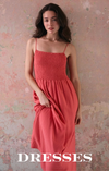 Woman in a coral dress. Shop dresses.