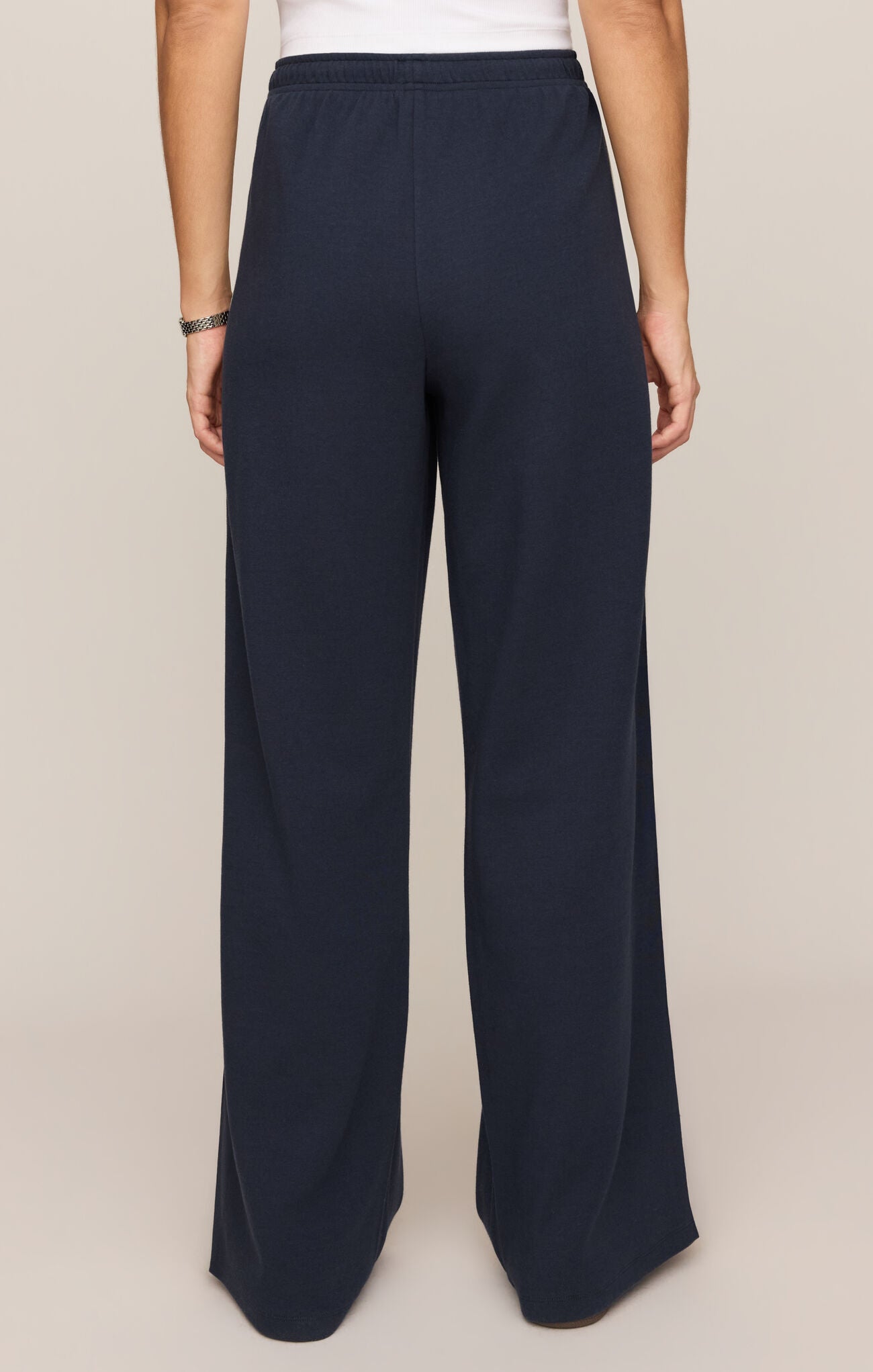 Back view of navy Eclipse Breakaway Track Pant by z supply with elastic waistband and wide legs.