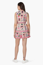 Woman wearing a sleeveless Print Mix Match Dress by America & Beyond with colorful patchwork and floral patterns standing back view.