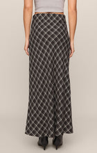 Rear view of Ash Black Europa Plaid Skirt by z supply, featuring an ankle-length black and white plaid design.