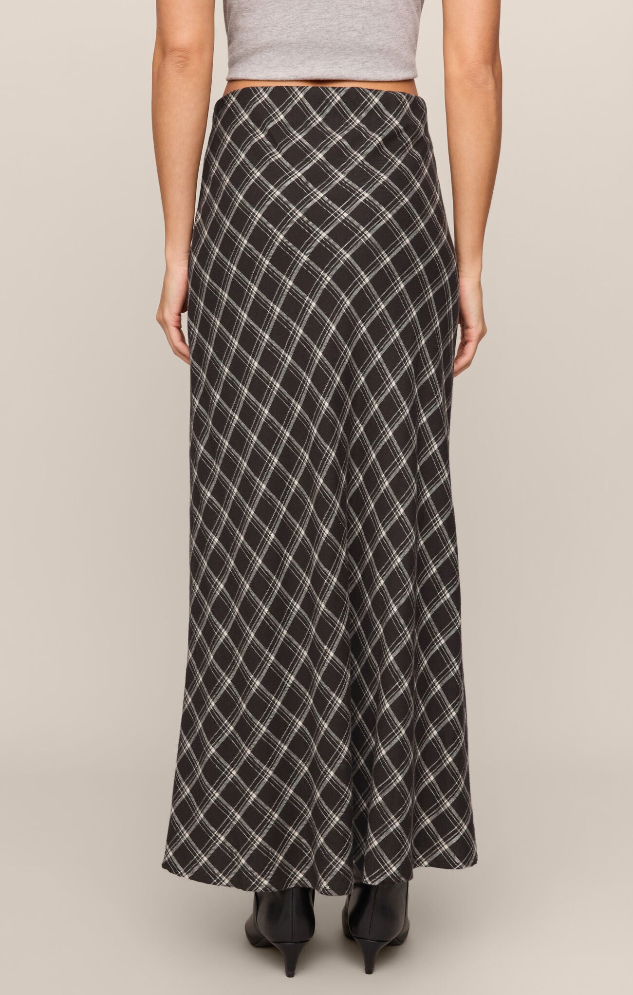 Rear view of Ash Black Europa Plaid Skirt by z supply, featuring an ankle-length black and white plaid design.