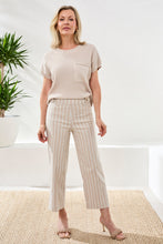 Woman wearing beige and white striped Tribal Stripe Pull-On Capri Pant paired with a neutral short sleeve top in bright room