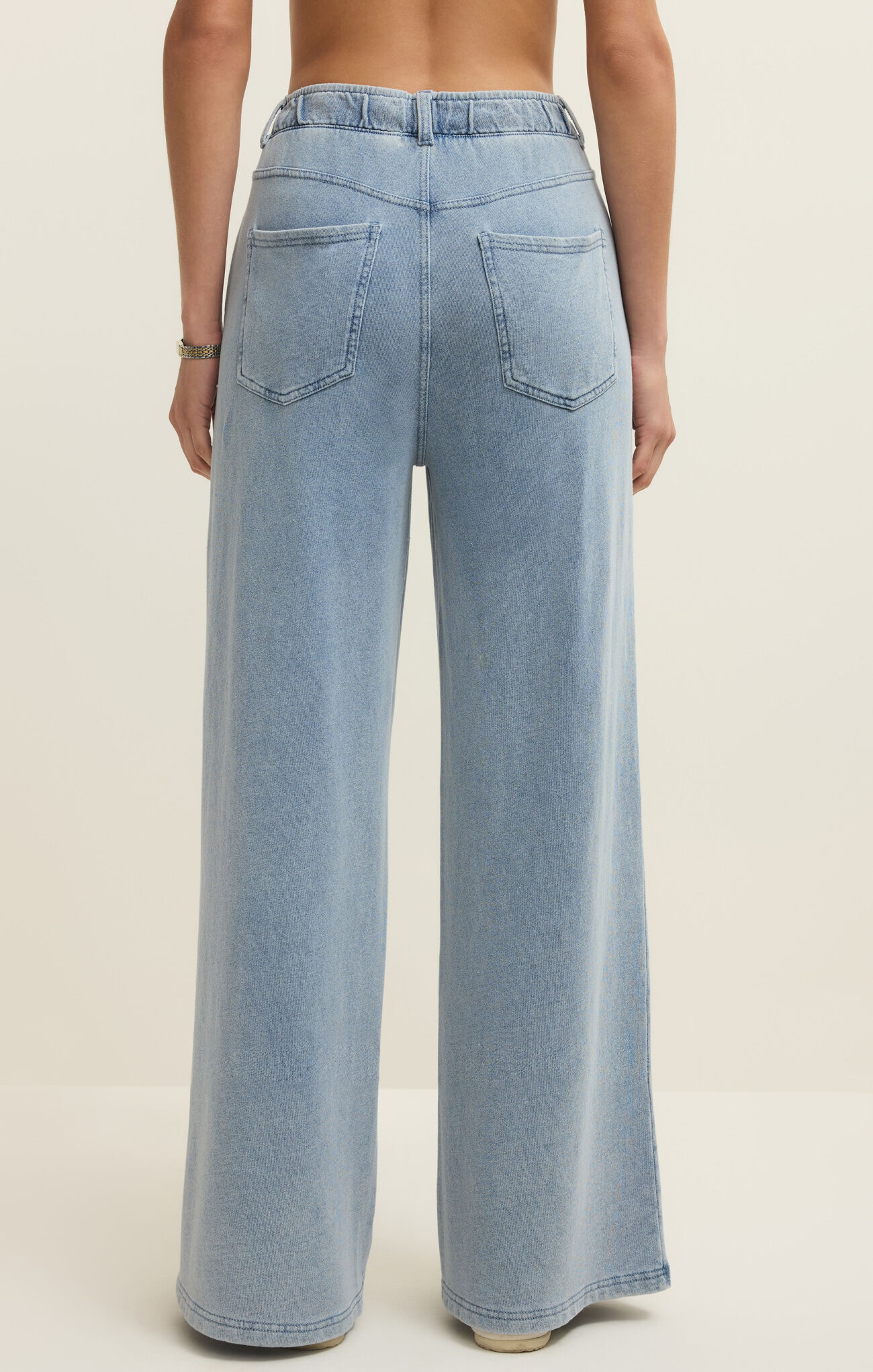Ocean Air Indigo Entrourage Knit Denim Pant by z supply shown from back in light wash wide leg style