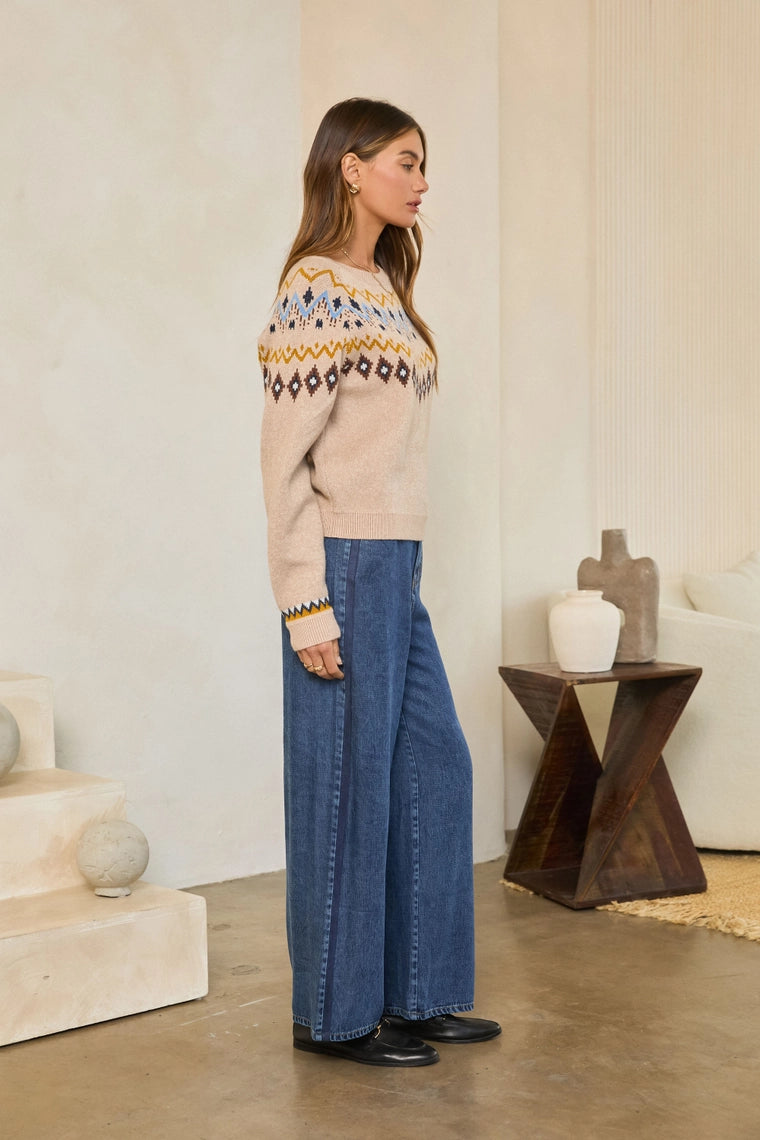 Neutral Mood Sweater by skies are blue worn with wide leg jeans in a warm neutral room