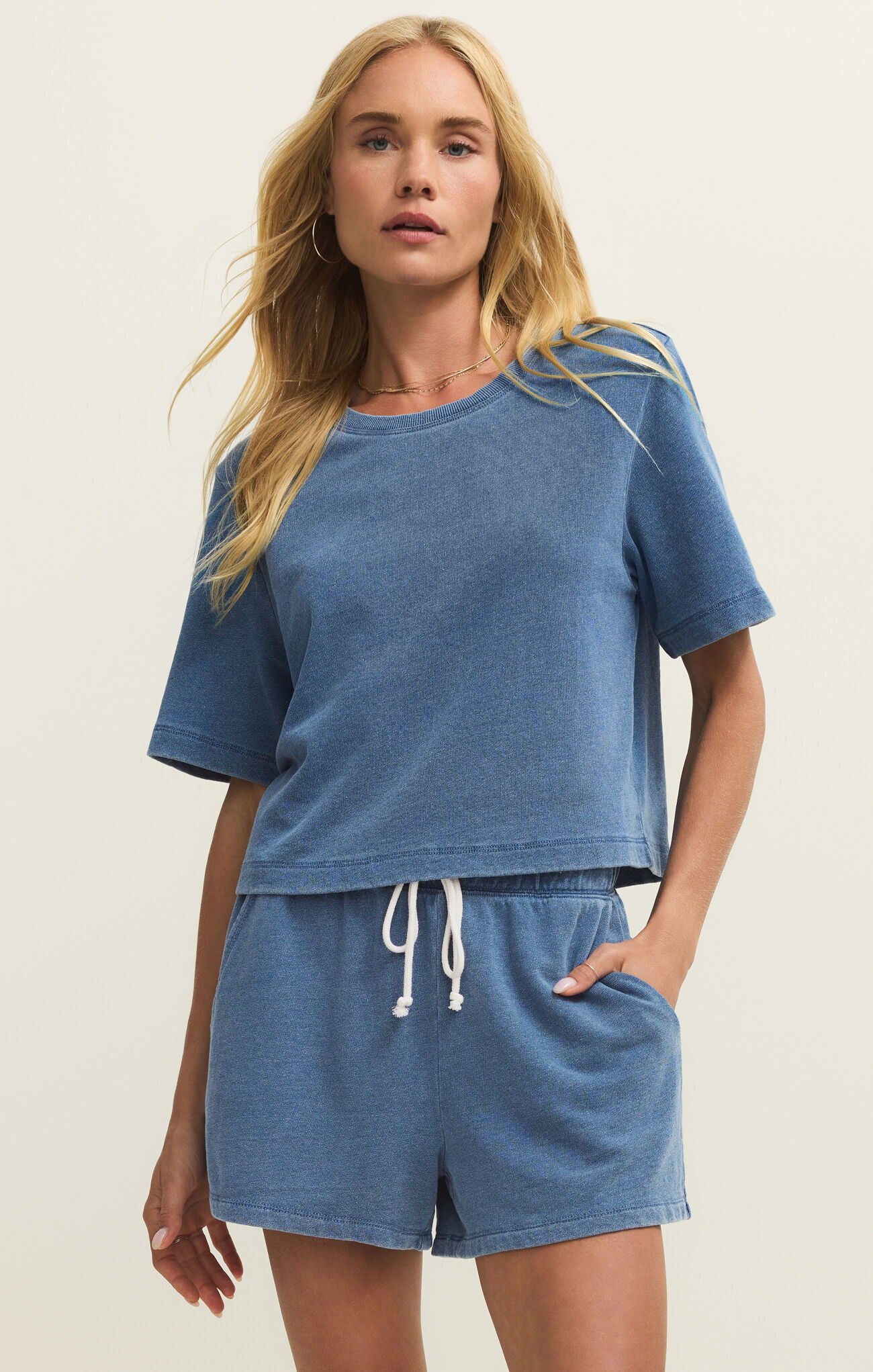 Woman wearing Calypso Blue Indigo Curran Knit Denim Sweatshirt by z supply with relaxed fit and soft denim knit texture