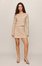 Woman wearing a beige Natural Cressa Cardigan and matching skirt by z supply with scalloped edges and intricate knit pattern