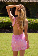 Young woman outdoors wearing a backless pink sequin Primavera Homecoming Dress style 4617 by primavera in sunlight