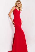 Model wearing a fitted red Jovani Prom Dress Style 49861 with thin straps and mermaid silhouette by JOVANI