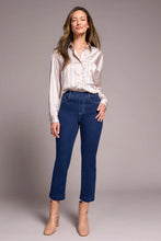 Woman wearing Tribal Audrey Pull-On Crop Straight Jeans with Front Crease styled with a striped blouse and beige ankle boots