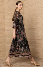 Black Adriel Print Maxi Dress by hale bob modeled in a flowing black floral dress with long sleeves