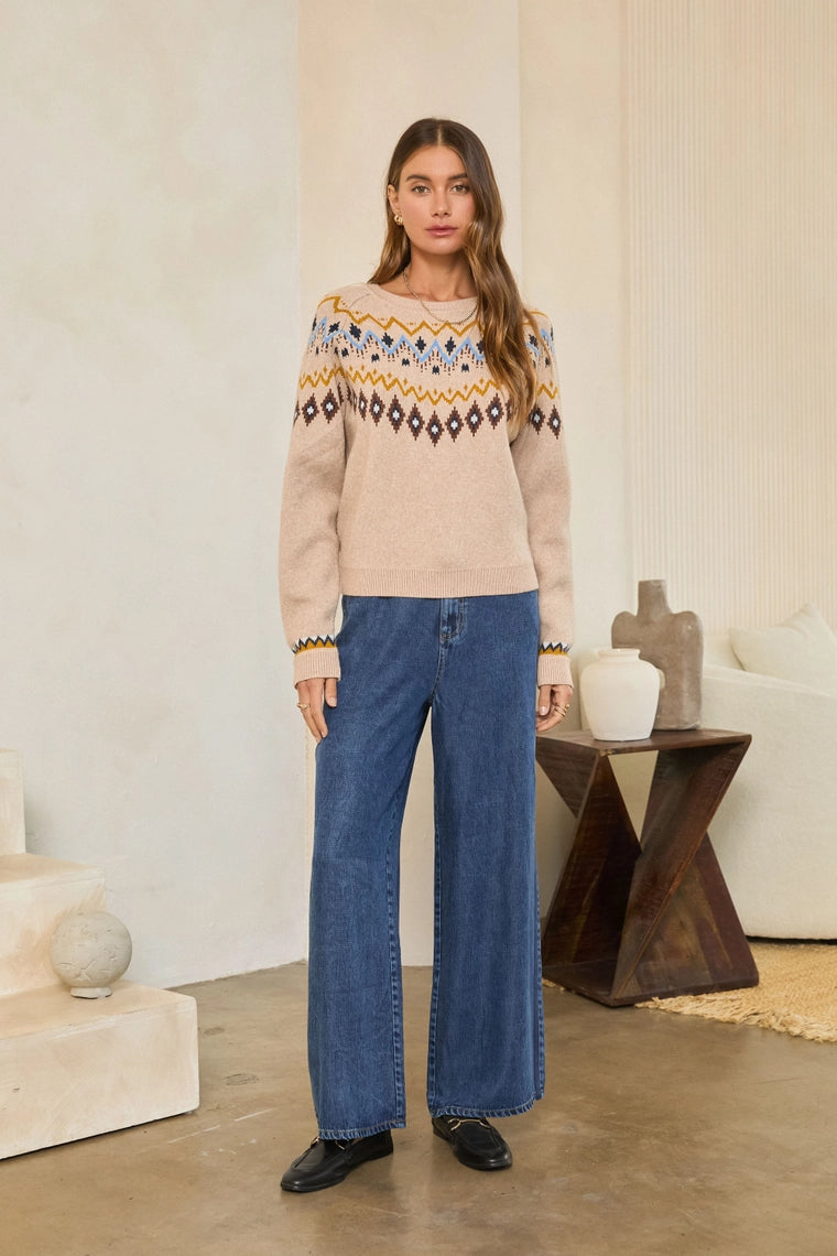 Neutral Mood Sweater by skies are blue worn with wide leg jeans in a neutral interior