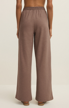 Back view of a model wearing Z Supply Milk Shake Andre Wide Leg Pant in a neutral tone with relaxed fit and elastic waistband