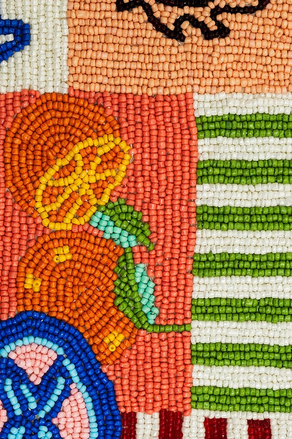 Close-up of colorful beadwork featuring fruit and stripes on the Sun & Sea Beaded Shoulder Bag by America & Beyond.