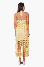 Back view of a model wearing Butter Yellow Opal Circle Radiance Dress by America & Beyond with circular embellishments.