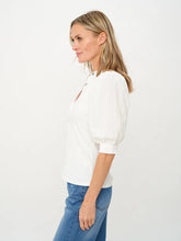 Side view of woman wearing White Mixed Media Tee Audrey by six/fifty with puffed sleeves and ribbed bodice
