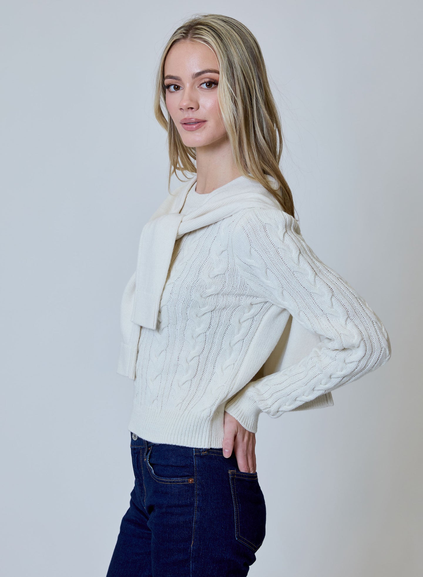 design history Canvas Double Layer Sweater in ivory cable knit with layered neckline modeled with jeans